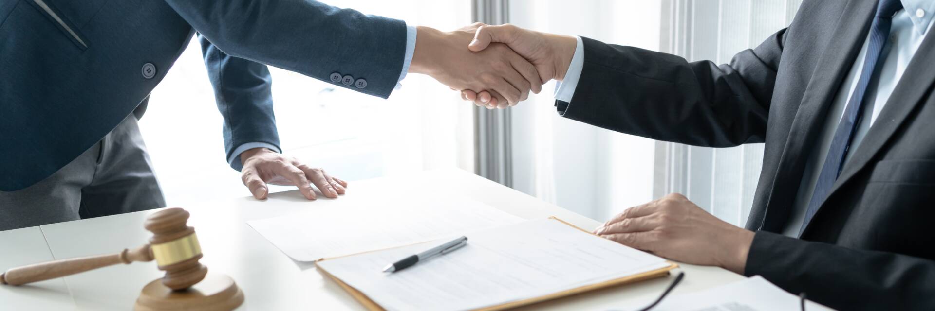 Legal counsel presents to the client a signed contract with gavel and legal law. justice and lawyer